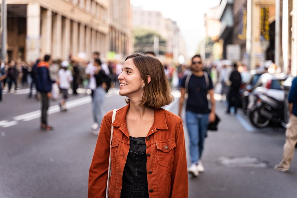 Person walking down the street looking around