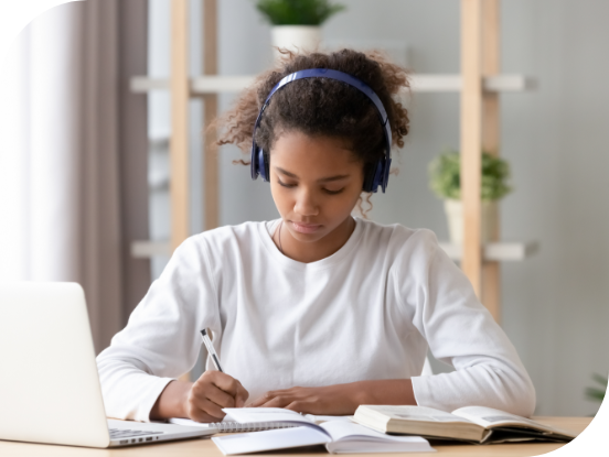 Student wearing headphones while doing homework